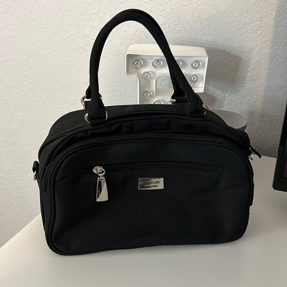 Black purse with individual card slots and phone holder. The filter New York